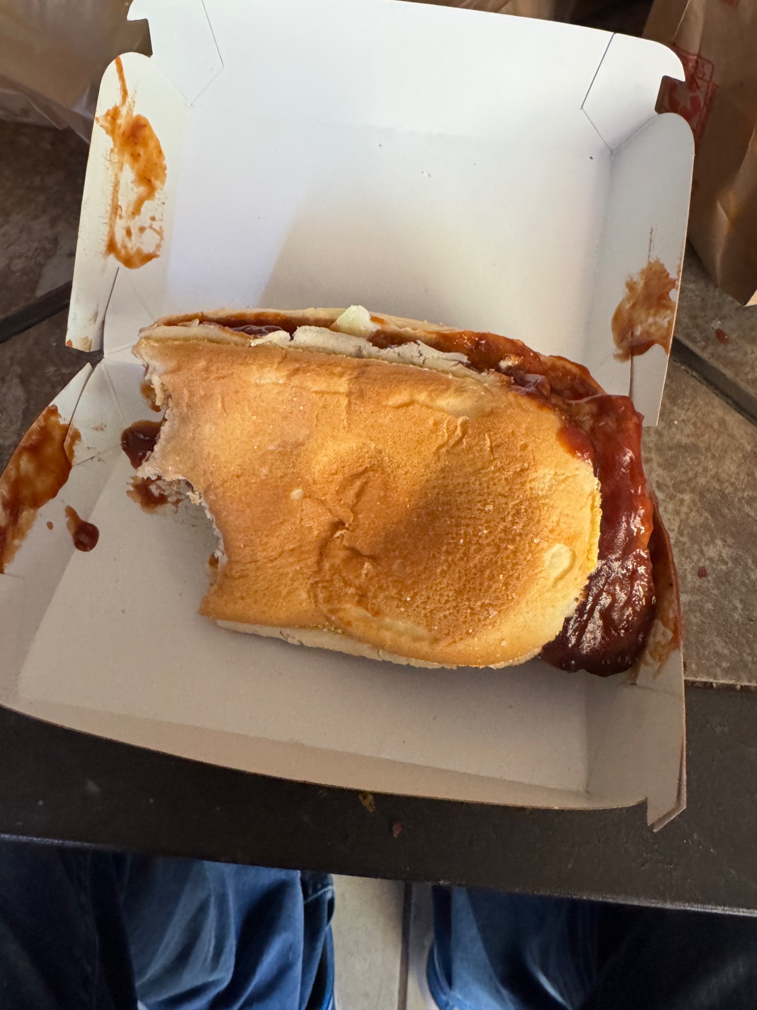 BBQ sandwich with sauce in a takeout box